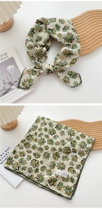 Close-up of floral cotton linen scarf with green lace edges and vintage pattern