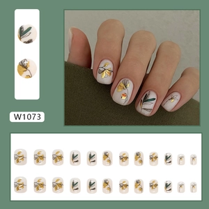 Short press-on nails with vintage botanical flower silhouette and gold foil art