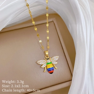 Macro shot of 3.3g gold bee necklace with rainbow enamel and wings set with crystals
