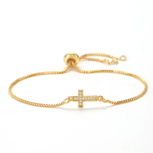 Detail of adjustable gold cross bracelet with micro-pave cubic zirconia and box chain