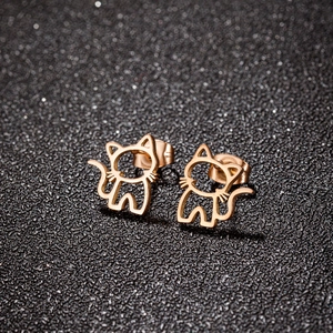 Minimalist hollow cat stud earrings in rose gold finish on a black glitter background
