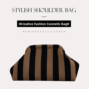 Detail of striped knitted tote bag featuring brown and black vertical weave texture