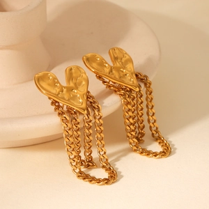 Detail view of 18K gold-plated stainless steel heart studs with delicate chain tassels