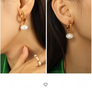 Detailed view of vintage gold hoop earrings with large pearls and matching pearl ring