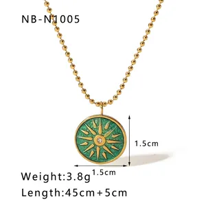 Macro detail of French vintage sunburst pendant necklace with green enamel and white zircon