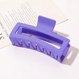 Macro detail of large purple matte rectangular hair claw clip for thick hair styling