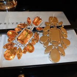 Vintage orange crystal drop earrings with geometric gold setting for elegant evening wear