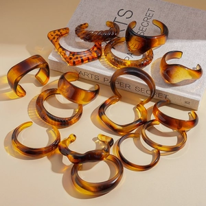Collection of amber acrylic resin open bangles with vintage tortoiseshell geometric designs