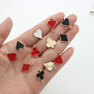Set of four poker card charms in red and black enamel with gold-tone plating