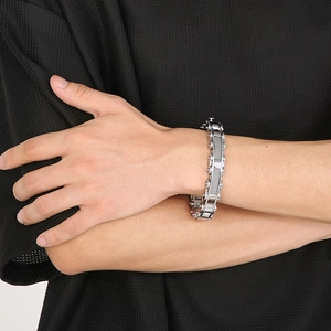 Men's silver titanium steel bicycle chain bracelet in industrial style on model's wrist