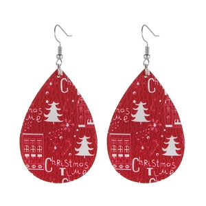 Close-up of red teardrop leather earrings featuring festive Christmas Time text and texture