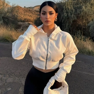 Women fashion white zip-up hooded knit cardigan with long sleeves in outdoor street style