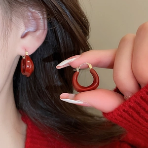 Créoles géométriques en U plaquées or 14K avec émail rouge portées par un mannequin