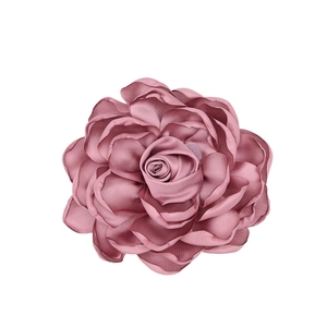 Macro view showing layered satin petals and detailed texture of the dusty pink fabric rose