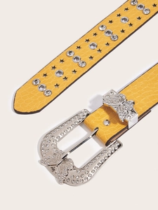 Detail of yellow leather belt with silver butterfly diamond buckle and star metal studs