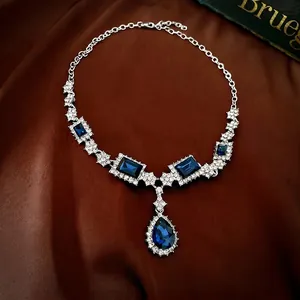 Luxury silver-plated jewelry set with deep blue teardrop and rectangular crystals