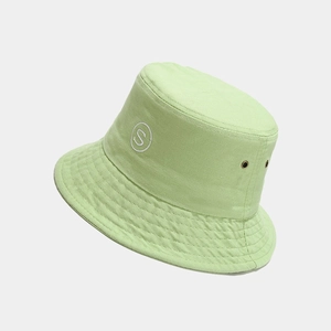 Detail of mint green bucket hat featuring 'S' embroidery and metal ventilation eyelets