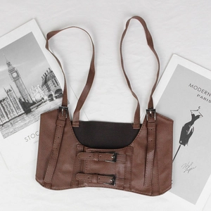 Brown vintage style leather corset belt with silver adjustable buckles on white background