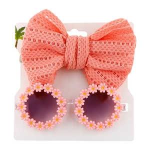 Detail of pink daisy round sunglasses and matching mesh bow headband for kids and babies