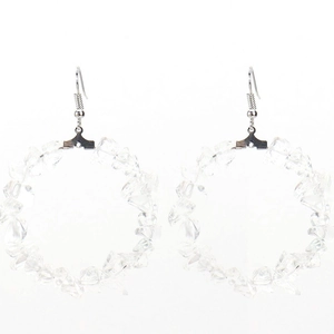 Close-up of circular hoop earrings with colorful irregular natural stone beads
