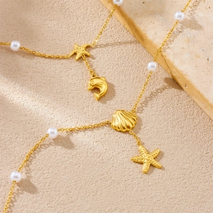 Golden stainless steel anklet featuring sea shell, starfish, dolphin charms and pearls