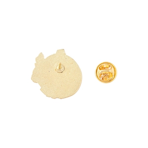 Detailed view of the gold metal badge back with butterfly clasp and textured finish