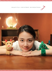 Child wearing Christmas plush reindeer and tree snap bracelets in cozy festive scene