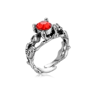 Gothic skull ring in vintage silver finish with a faceted red gemstone center