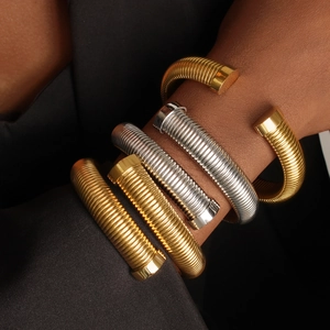 Set of three textured titanium steel open bangles in gold and silver finish for layering