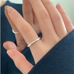 Detailed view of simple 925 sterling silver ring with smile face worn on hand