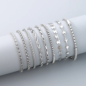 Detail of 8 silver stainless steel anklet styles including heart and bead chain designs