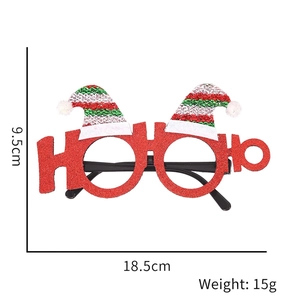 Detail of red glitter Christmas glasses with Santa hat design and HO HO HO text