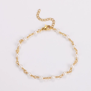 Detail of wire-wrapped baroque pearls on a gold chain with adjustable lobster clasp closure