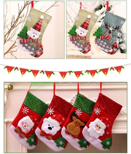 Detail of sequined Christmas stockings with 3D Santa, snowman and reindeer figures