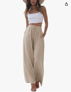 Detailed macro view of the drawstring elastic waist and texture on beige linen trousers