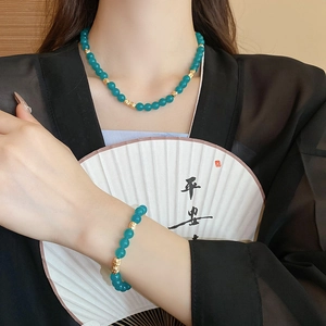 Vintage Chinese style necklace and bracelet set with green beads and gold accents