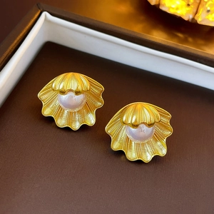 Golden shell earrings with white pearl inlay in a premium vintage aesthetic style
