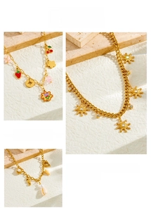 Detail of nautical stainless steel necklace with enamel dolphin, pearl and starfish charms