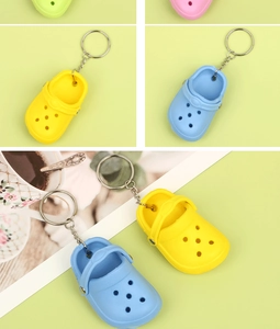 Macro detail of colorful mini clog shoe keychains with metallic ring and silver chain