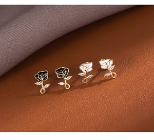 Macro detail of French vintage rose earrings in black and white with gold finish