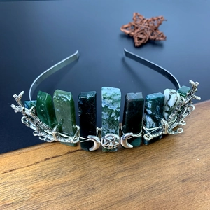 Detail view of green natural crystals with silver crescent moon pendants on bridal headband