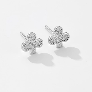 Macro detail of silver clover earrings featuring sparkling pavé cubic zirconia inlay