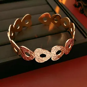 Vintage hollow heart pattern open bangle in gold finish with floral relief texture
