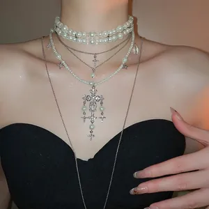 Elegant layered pearl necklace with sparkling rhinestone cross pendants and silver accents