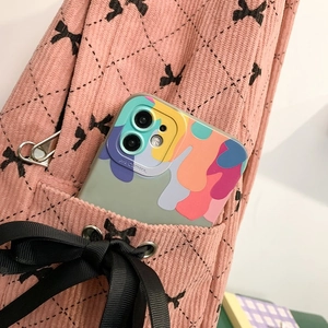 Detailed view of pink corduroy texture and decorative black ribbon bow on a school backpack