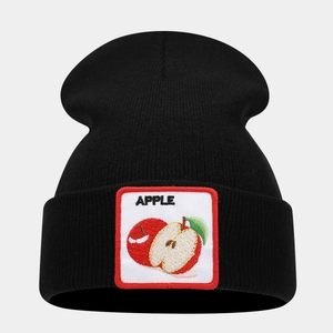 Detail of black knit beanie with square embroidered apple patch and folded cuff