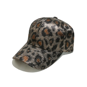 Detail shot of the metallic leopard print texture and stitching on the baseball cap