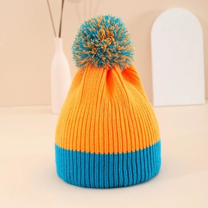 Winter knitted beanie in orange and blue color block design with a fluffy pompom detail