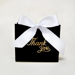 Elegant black gift box with a white silk ribbon and gold Thank You lettering