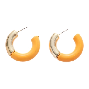 Fashionable gold-plated and yellow resin C-shaped hoop earrings on white background